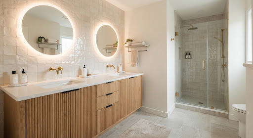 Guest bathroom design inspiration with an oak vanity, round mirrors, quartz counter, and textured tile